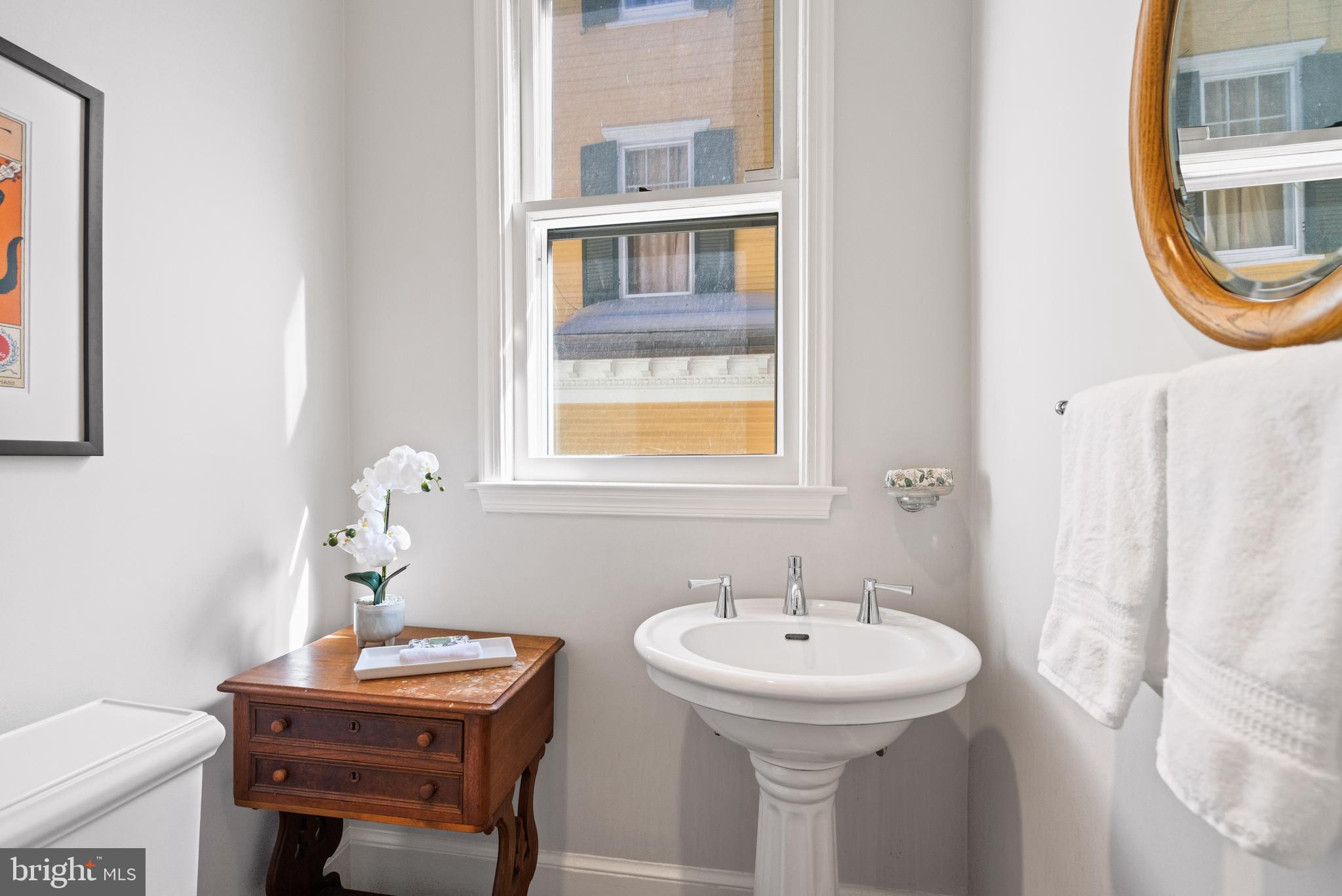3214 Newark Street Northwest Washington, DC 20008 - Photo 12 of 38 a bathroom with a sink and a mirror