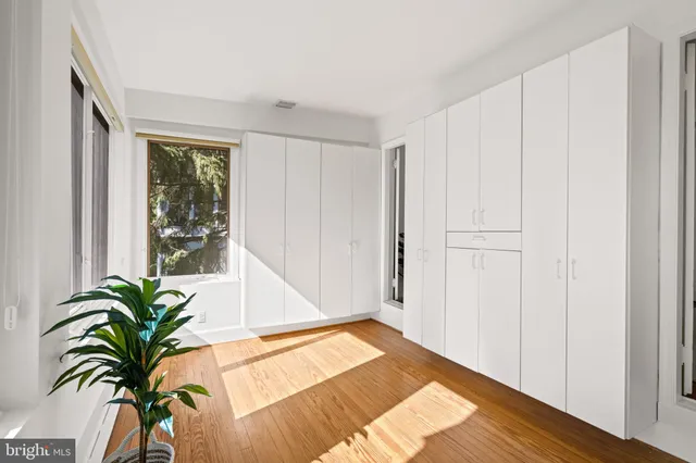 a view of a room with a window and wooden floor