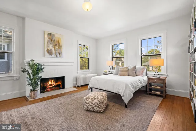 a spacious bedroom with a bed and a fireplace