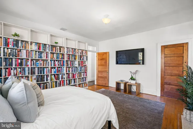a bedroom with a bed and a flat screen tv