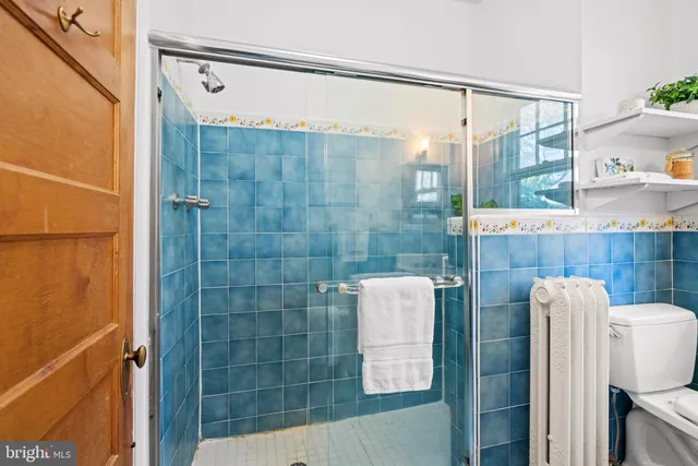 a bathroom with a shower and a sink