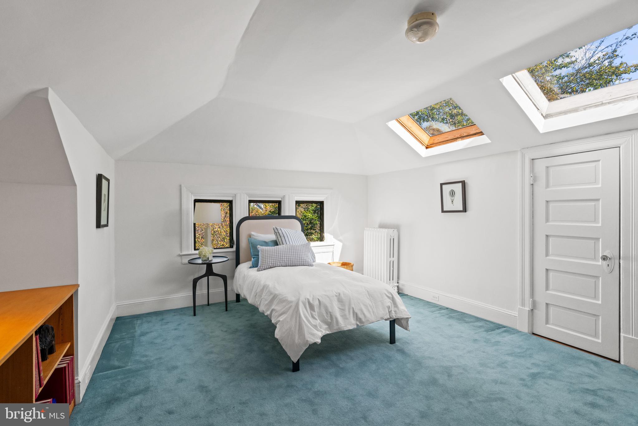 3214 Newark Street Northwest Washington, DC 20008 - Photo 25 of 38 a bedroom with a bed and a chandelier