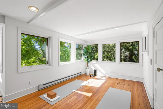a view of a room with wooden floor and pool table