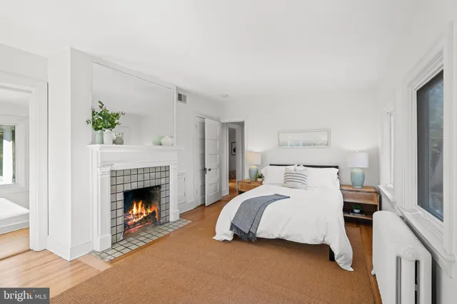 a bedroom with a bed and a fireplace