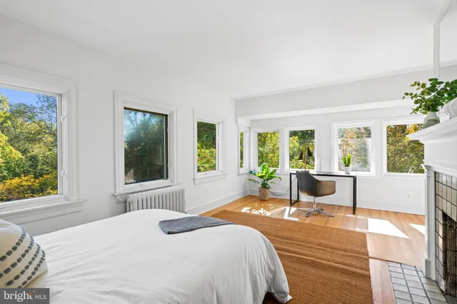 a bedroom with a large window and a table