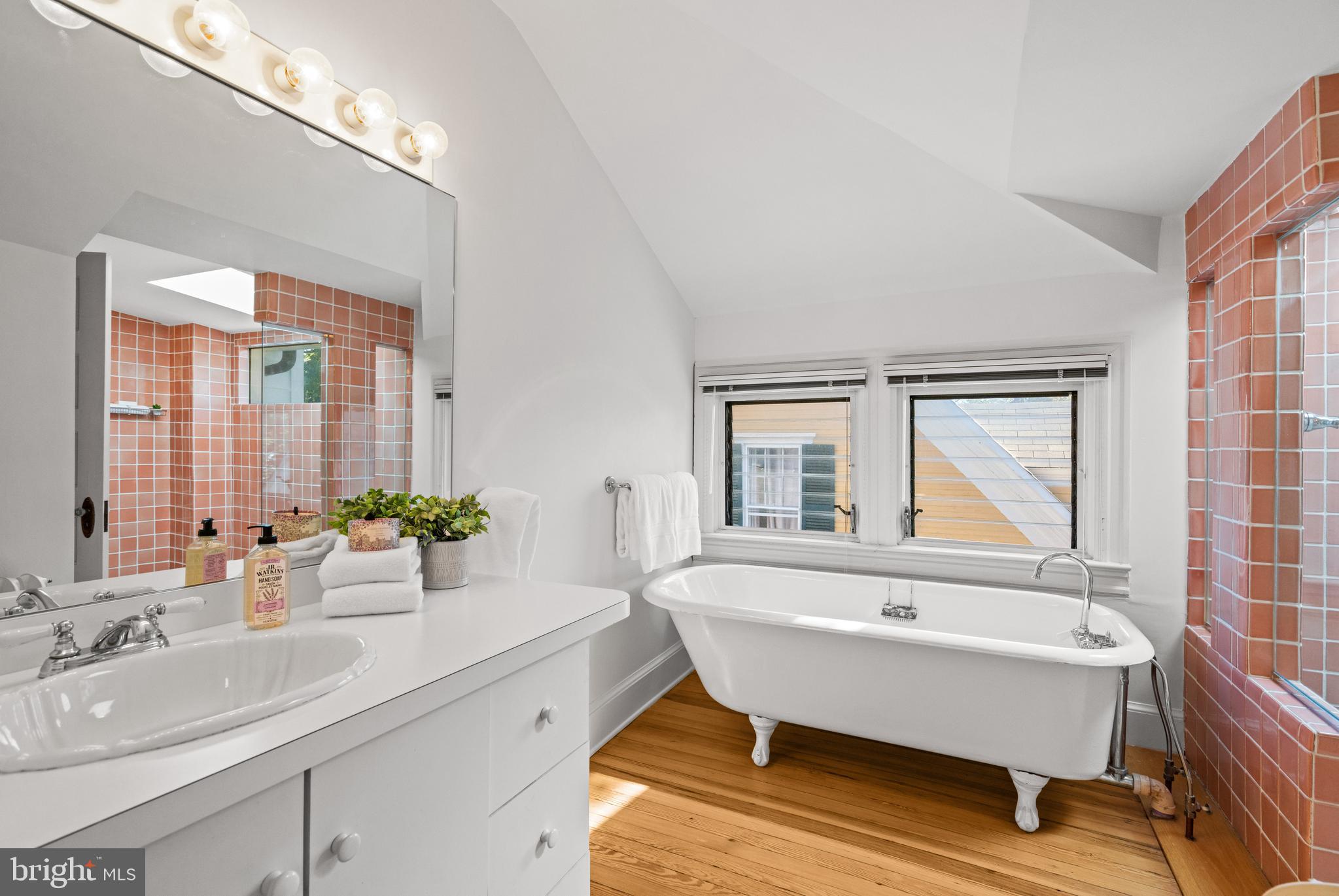3214 Newark Street Northwest Washington, DC 20008 - Photo 32 of 38 a bathroom with a sink mirror and a bathtub