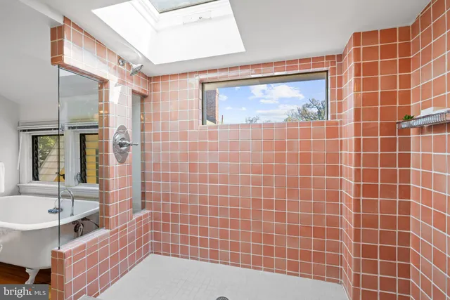a bathroom with a bathtub and a shower