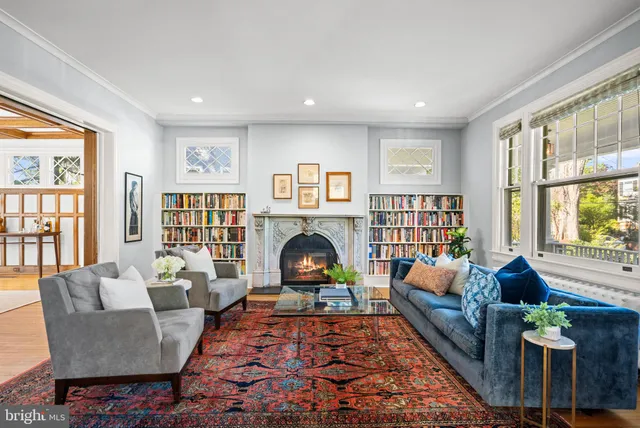 a living room with furniture fireplace and window