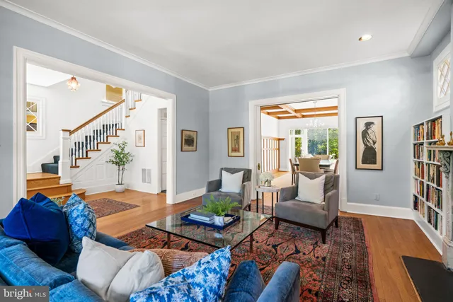 a living room with furniture and a book shelf