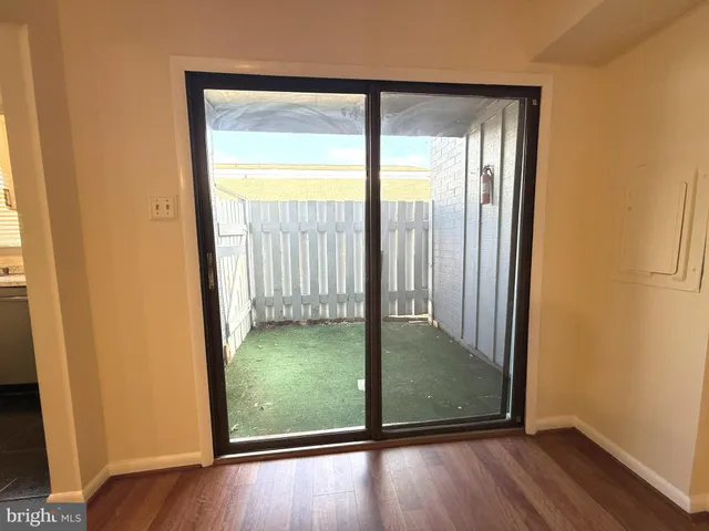 an empty room with wooden floor and door