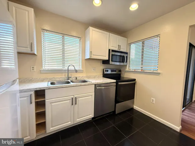 a kitchen with a sink cabinets and window