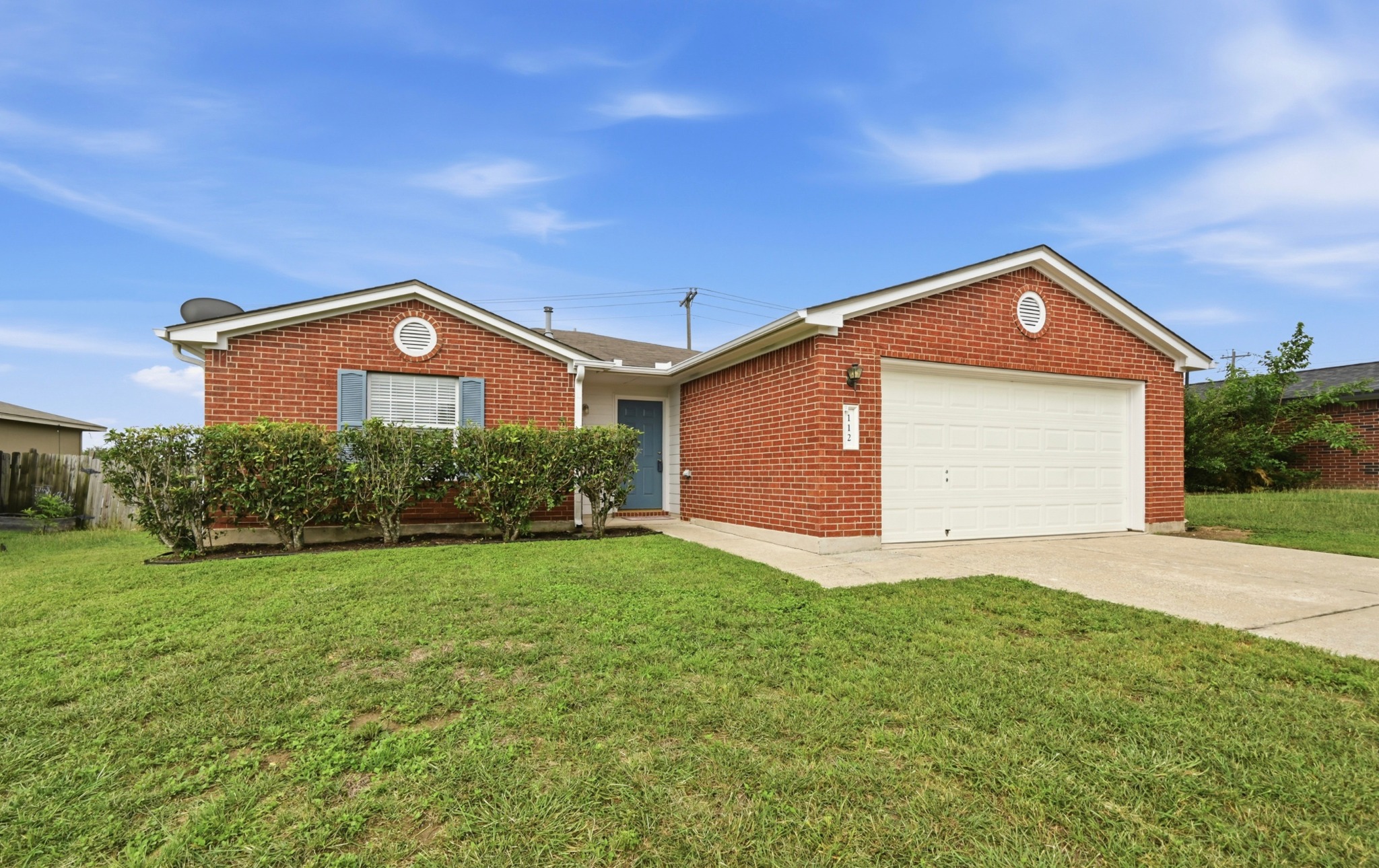 112 Mason Reed Cove Kyle, TX 78640 - Photo 1 of 26 a front view of a house with a yard and garage