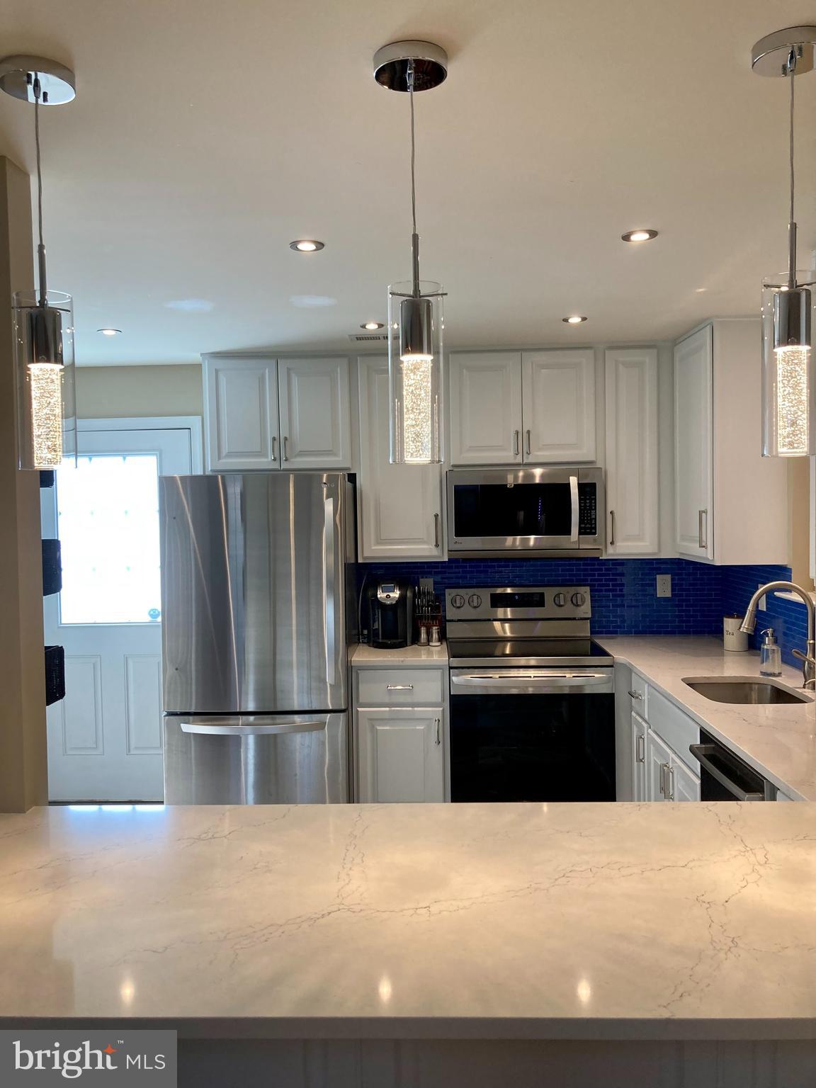306 Ohio Avenue Wilmington, DE 19805 - Photo 4 of 13 a kitchen with stainless steel appliances granite countertop a refrigerator a stove a sink and a refrigerator