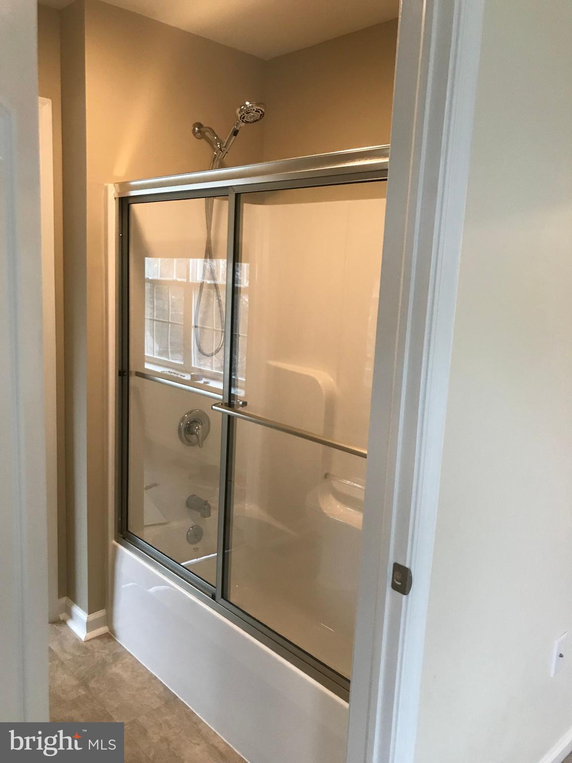306 Ohio Avenue Wilmington, DE 19805 - Photo 9 of 13 a bathroom with a glass shower door