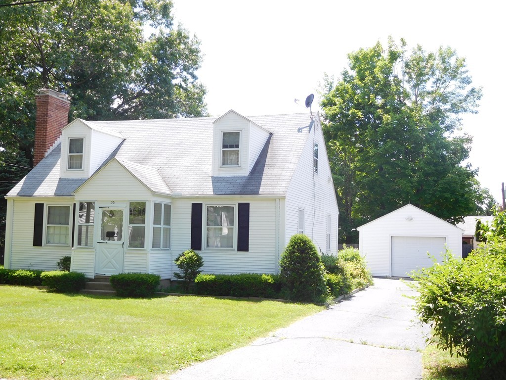 30 Elizabeth Street Springfield, MA 01109 - Photo 1 of 19 a view of a white house next to a yard with plants and large trees