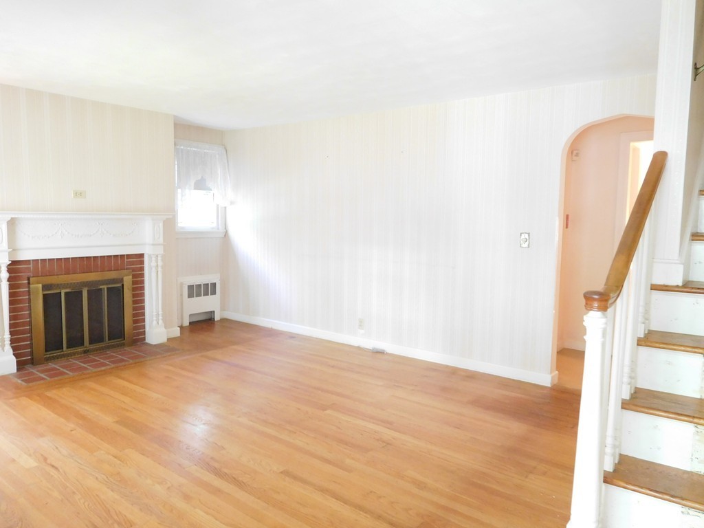 30 Elizabeth Street Springfield, MA 01109 - Photo 6 of 19 a view of empty room with wooden floor and fireplace