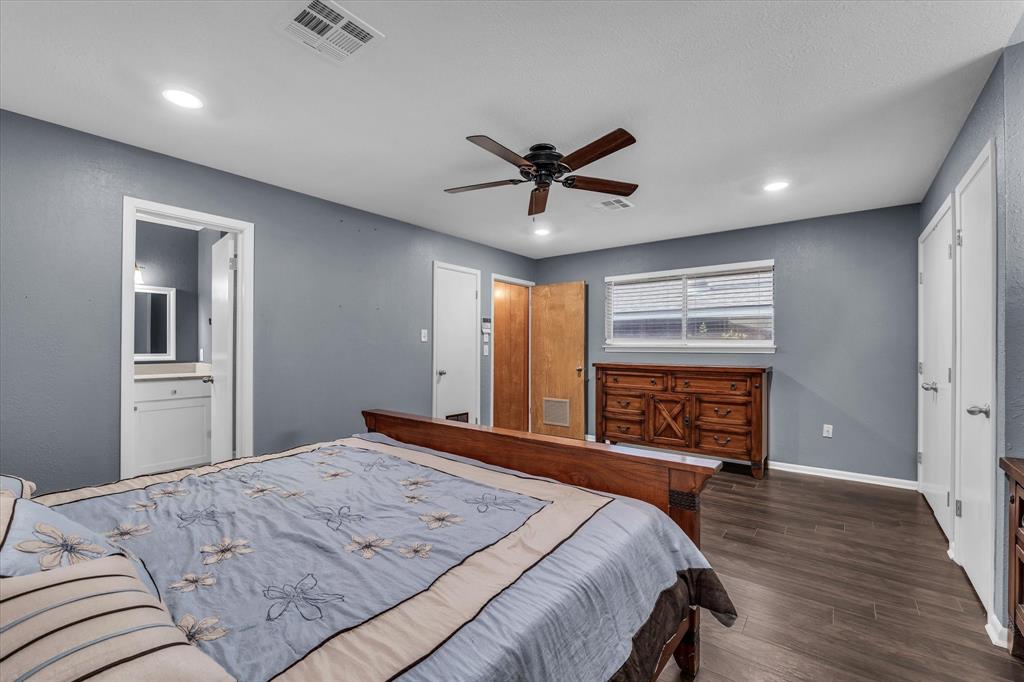 4325 Shady Glen Drive Waco, TX 76708 - Photo 14 of 40 a bedroom with a bed and a chandelier