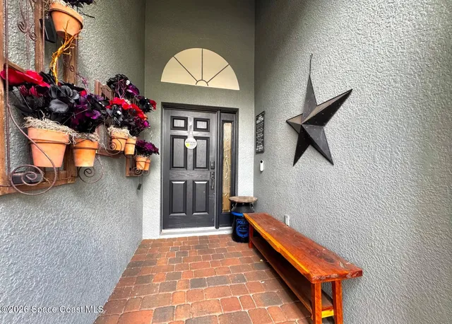 a hallway with beautiful frames and flower vase