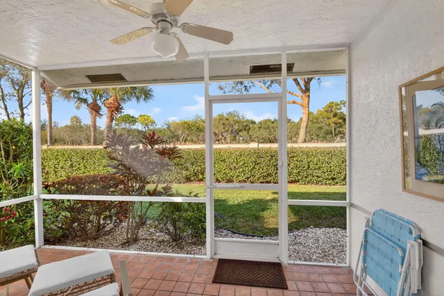a living room with lots of furniture and view of kitchen