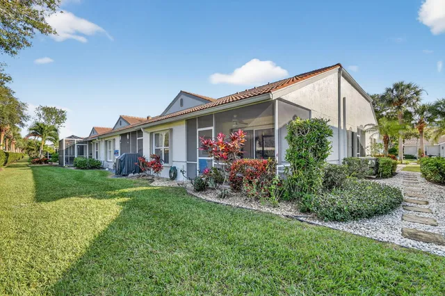a living room with furniture a flat screen tv and floor to ceiling window