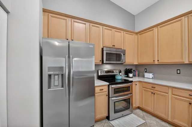 a kitchen with stainless steel appliances a refrigerator stove and microwave
