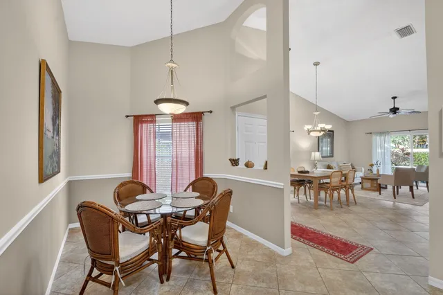 a view of a dining room with furniture and window