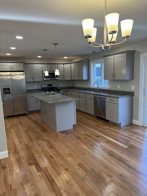 44 Downing Street Fall River, MA 02723 - Photo 2 of 10 a kitchen with stainless steel appliances granite countertop a sink and stove top oven