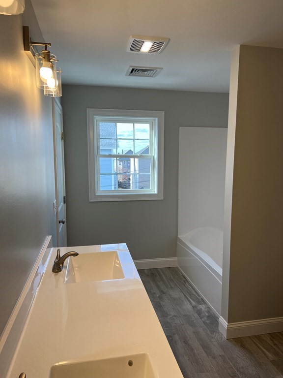 44 Downing Street Fall River, MA 02723 - Photo 9 of 10 a bathroom with a tub and a mirror