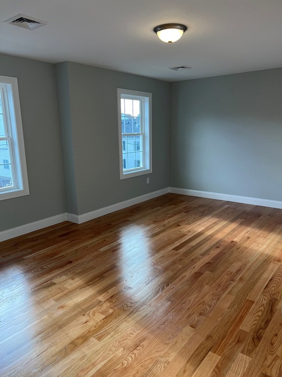 44 Downing Street Fall River, MA 02723 - Photo 10 of 10 a view of an empty room with wooden floor and a window