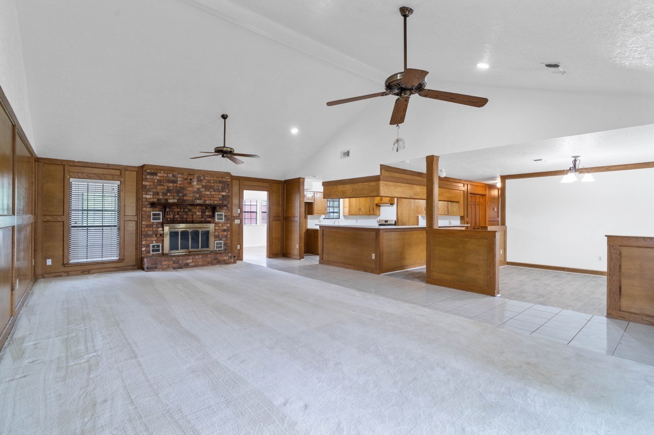 13180 Morgan Drive Splendora, TX 77372 - Photo 5 of 38 View of the dining area and kitchen from the living room. The open doorway leads out to the sunroom.