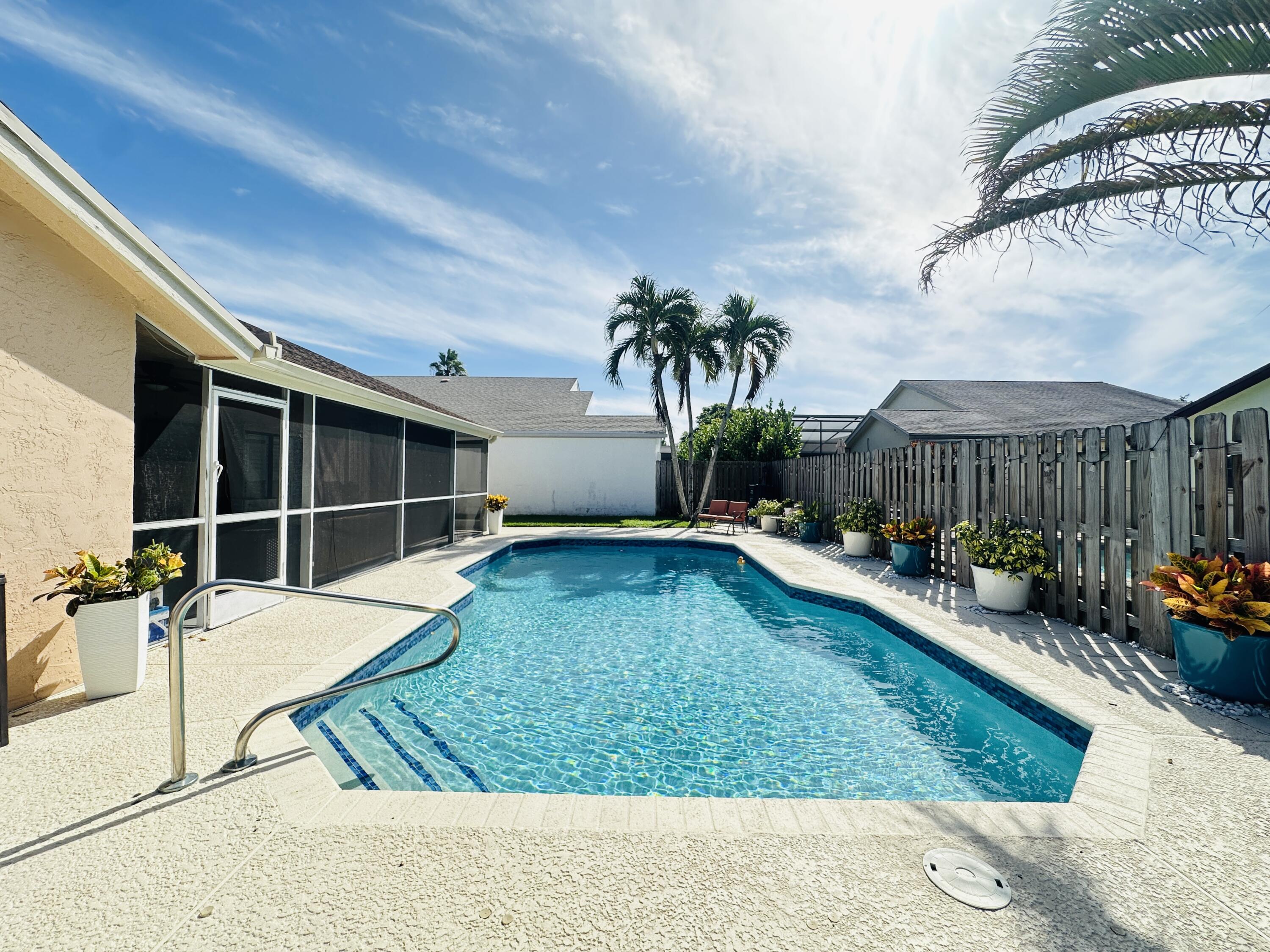 a view of a house with swimming pool and sitting area
