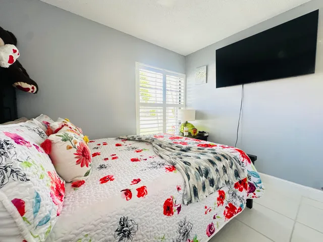 a bedroom with a bed and a tv in it