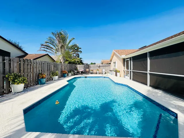 a view of an house with backyard space and swimming pool