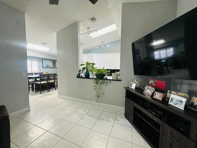 a kitchen with stainless steel appliances kitchen island granite countertop a sink and cabinets