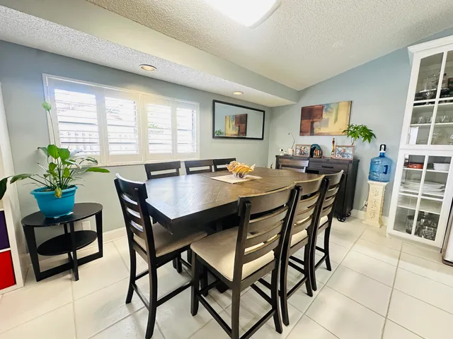 a view of a dining room with furniture and a window