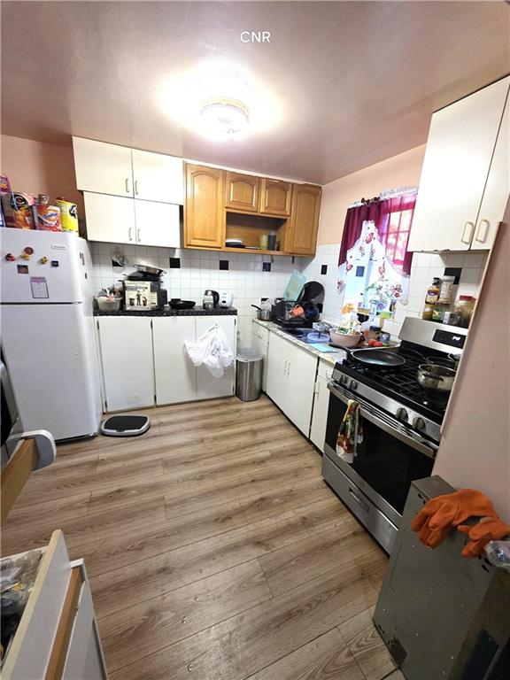408 Madison Street Brooklyn, NY 11221 - Photo 13 of 17 a kitchen with stainless steel appliances granite countertop a stove and white cabinets