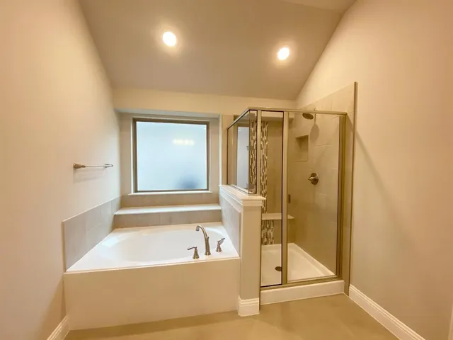a bathroom with a bathtub and a shower