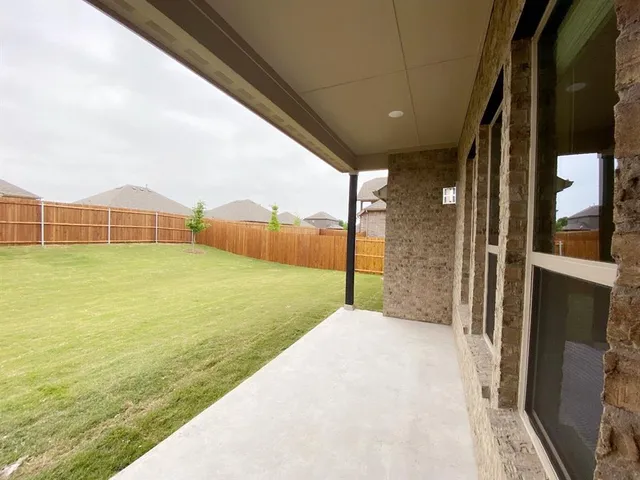 a house with huge green field in front of it