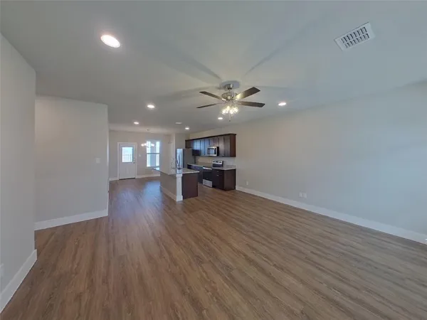 a view of an empty room and wooden floor