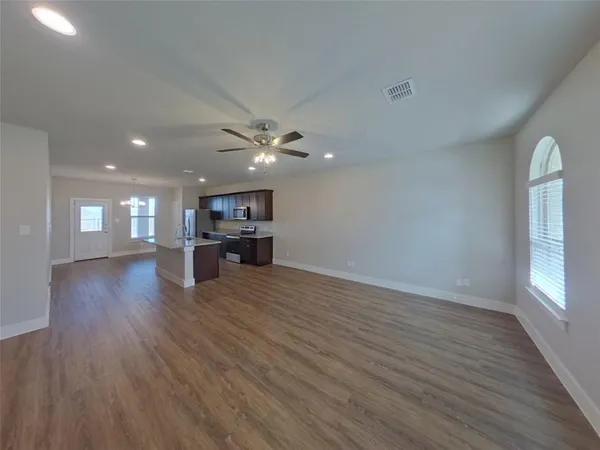 a view of a room with kitchen and window