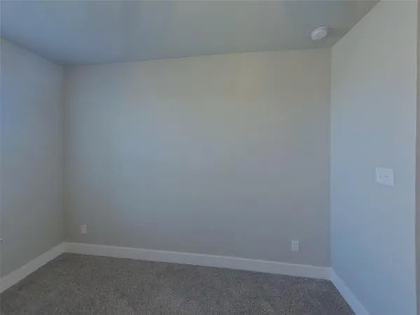 a bathroom with a granite countertop toilet sink and mirror