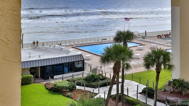 a front view of a house with garden and patio