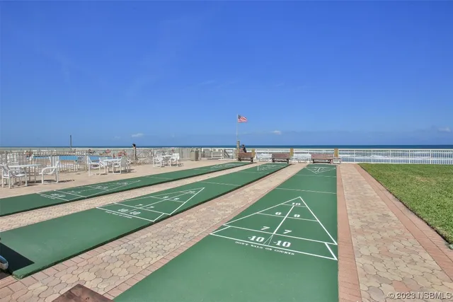 a kitchen with stainless steel appliances a dining table and chairs with wooden floor