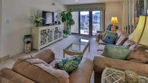 a living room with furniture fireplace and a large window