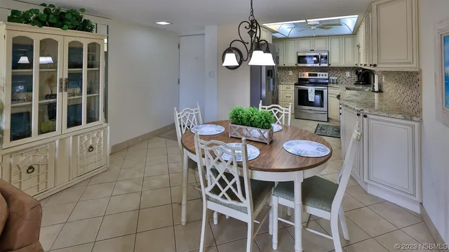 a view of a dining room with furniture and chandelier