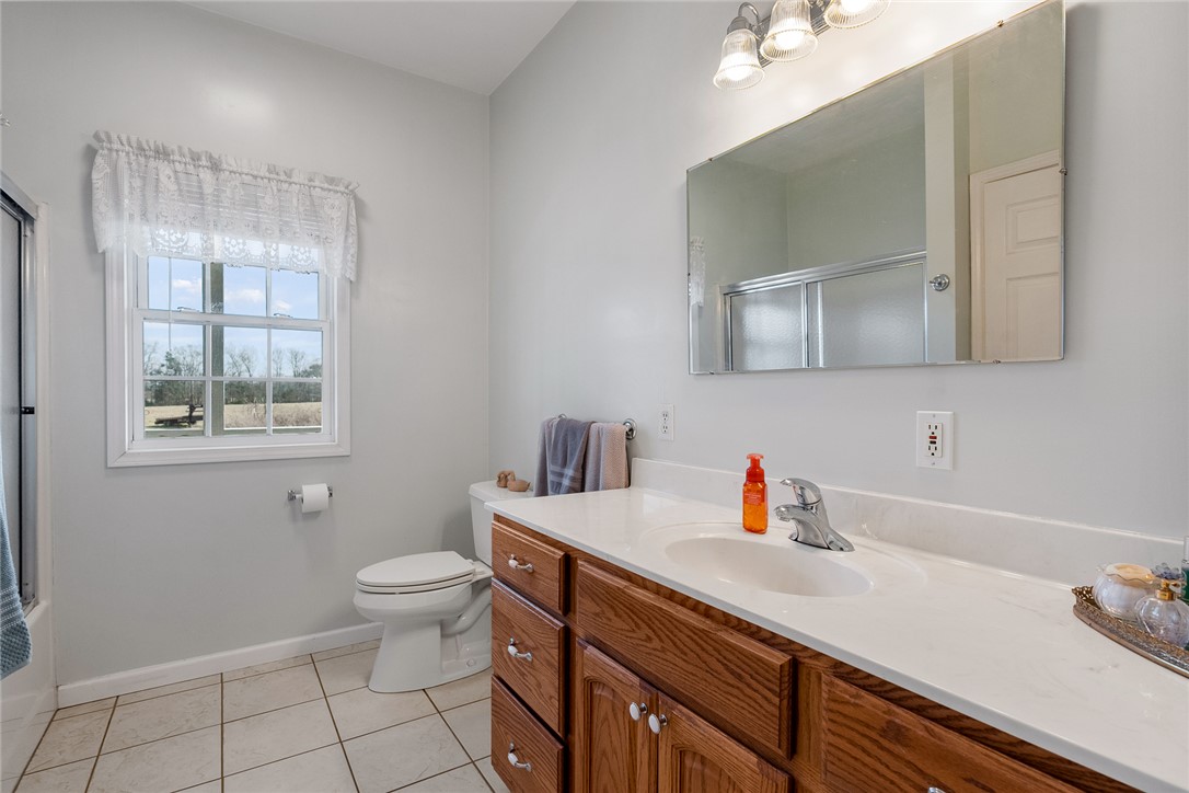 2803 Trail Road Belton, SC 29627 - Photo 17 of 48 This bright bathroom features a vanity with ample storage and a window offering natural light.