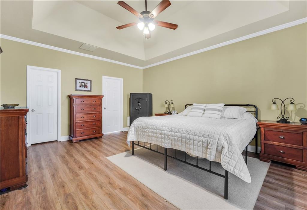 340 Roland Manor Drive Dacula, GA 30019 - Photo 12 of 50 a spacious bedroom with a bed and a chandelier