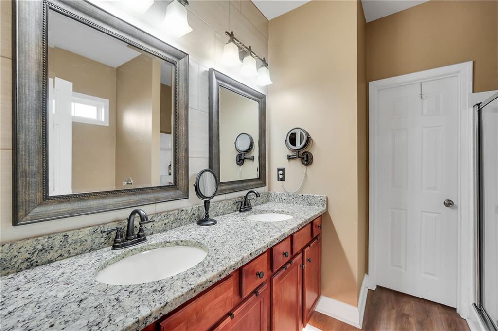340 Roland Manor Drive Dacula, GA 30019 - Photo 15 of 50 a bathroom with a granite countertop sink and a mirror