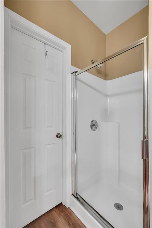 340 Roland Manor Drive Dacula, GA 30019 - Photo 18 of 50 a bathroom with a glass shower door