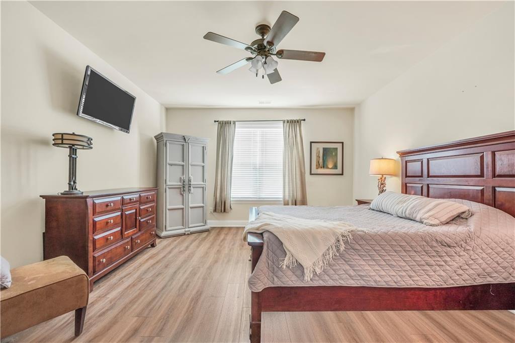 340 Roland Manor Drive Dacula, GA 30019 - Photo 19 of 50 a bedroom with a bed and a flat screen tv